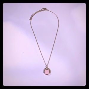 Gold necklace with pink spinning pendant